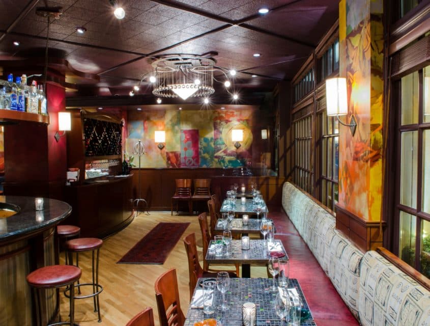 View of the bar, seating area and the vibrant wall of the Andaluca Restaurant.