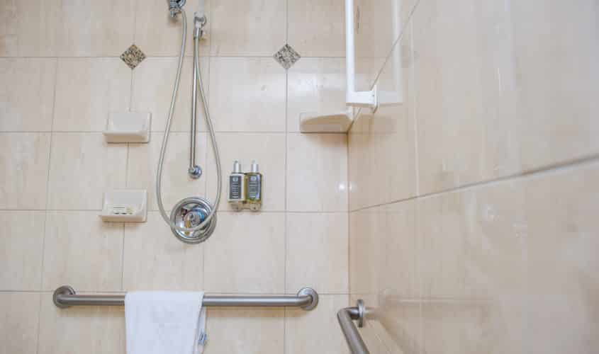 Spacious shower with grab bars and adjustable shower head at Mayflower Park Hotel in Seattle