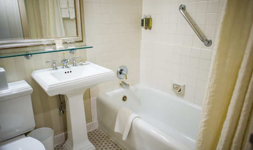 Seattle hotel guestroom featuring toilet, basin & tub with grab bar