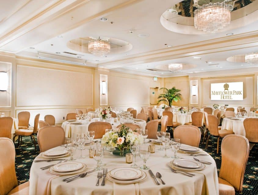 The Plymouth Room at Mayflower Park Hotel set for a seated event with multiple round tables