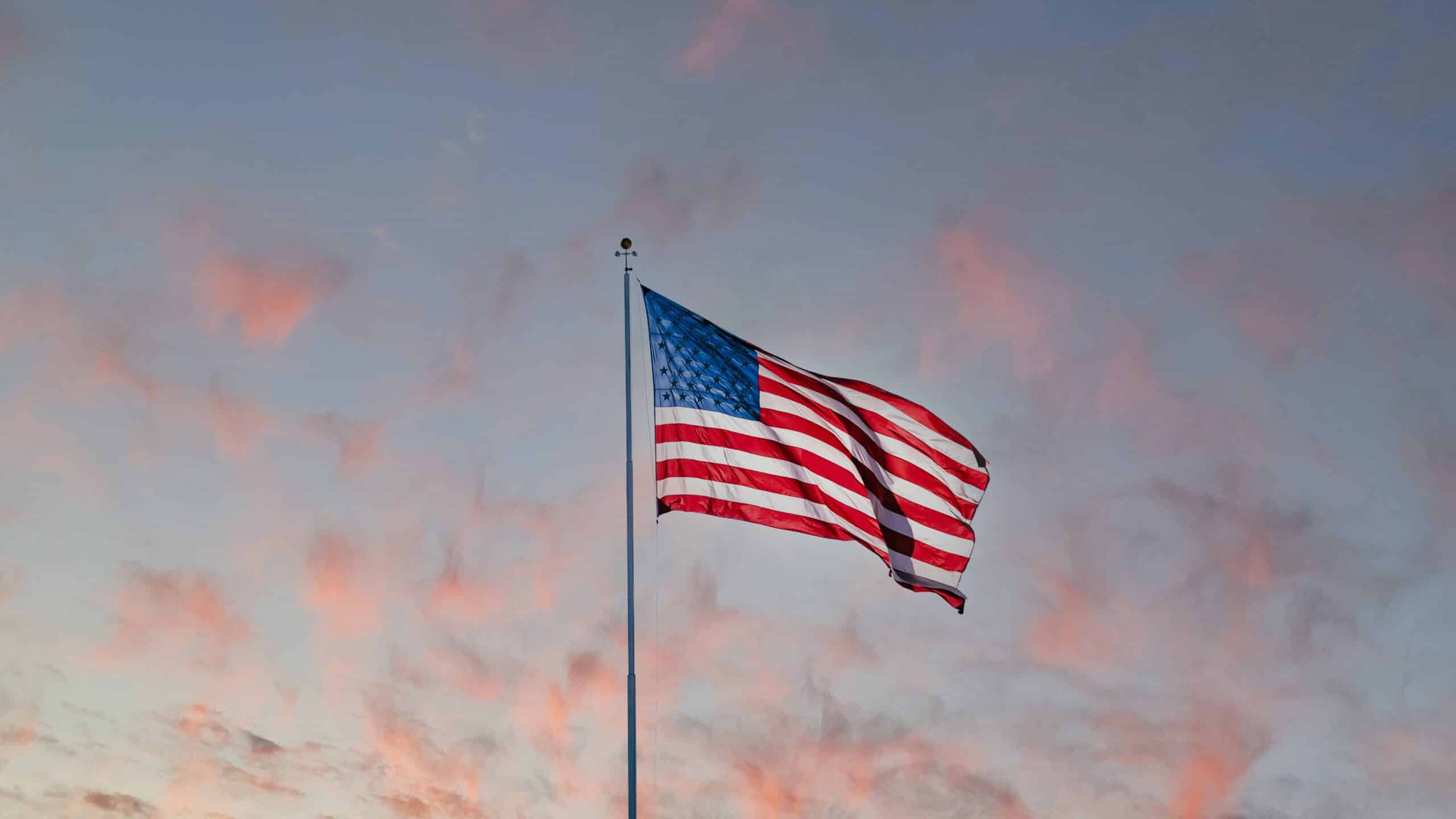 american flag in front of a sunset
