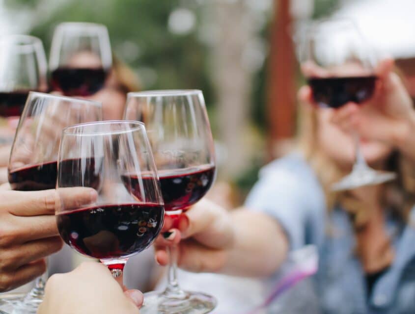 glasses of red wine in a cheers