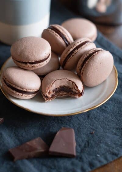 Plate of French macaroons, one with a bite taken out of it, at Andaluca Restaurant.